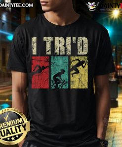 Alt Text: Happy I Tri'D Retro Vintage Triathlon T-Shirt featuring a colorful design of a triathlete swimming, biking, and running.
