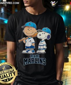 Alt Text: Happy Miami Marlins Charlie Brown and Snoopy baseball cartoon fan t-shirt featuring vibrant graphics and playful design.