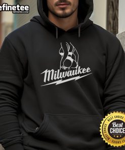 Attractive woman wearing a stylish 'Hot Milwaukee' hoodie, showcasing trendy fashion and urban style in a vibrant setting.