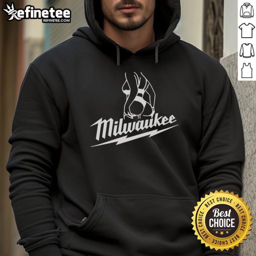 Attractive woman wearing a stylish 'Hot Milwaukee' hoodie, showcasing trendy fashion and urban style in a vibrant setting.