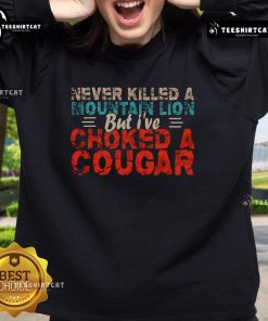 Funny Never Killed A Mountain Lion But I've Choked A Cougar Sweatshirt design featuring a humorous graphic and bold text.