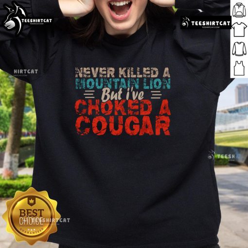 Funny Never Killed A Mountain Lion But I've Choked A Cougar Sweatshirt design featuring a humorous graphic and bold text.