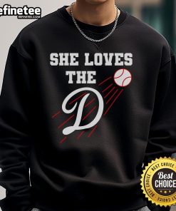 Woman wearing a Nice Baseball sweatshirt, 'She Loves The D' design, showcasing Los Angeles style and comfort.