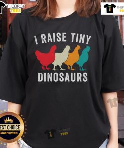 Charming backyard chickens with a humorous 'Tiny Dinosaurs' tee for chicken lovers on a cozy homestead.