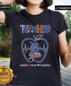 Detroit Tigers teacher tee featuring 'Teach, Love, Inspire' design with apple graphic for dedicated educators and fans.