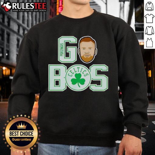 Kristaps Porzingis wearing a Boston Celtics sweatshirt, showcasing team spirit and style during a game.