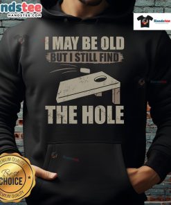 Nice I May Be Old But I Still Find The Hole Cornhole Hoodie displayed on a model, showcasing its fun design and cozy fit.