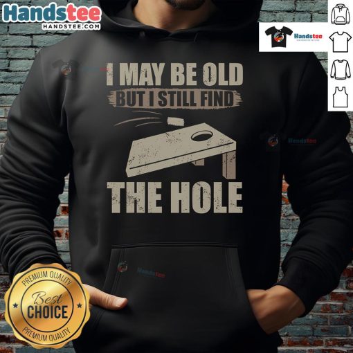 Nice I May Be Old But I Still Find The Hole Cornhole Hoodie displayed on a model, showcasing its fun design and cozy fit.
