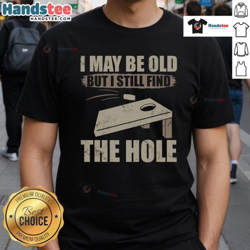 Funny cornhole t-shirt saying 'I May Be Old But I Still Find The Hole' perfect for cornhole enthusiasts.