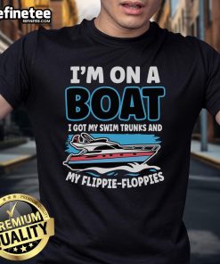 Person on a boat wearing swim trunks and a floppy t-shirt, enjoying a sunny day on the water, embodying 'Nice, I'm on a Boat' vibe.