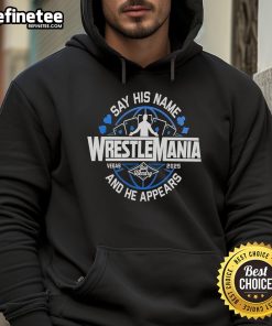 Alt Text: Joe Hendry wearing a WrestleMania hoodie, showcasing his catchphrase 'Say His Name' at a wrestling event.