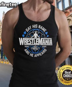 Alt Text: Joe Hendry wearing a 'Say His Name' Wrestlemania tank top, showcasing his wrestling persona and vibrant style.
