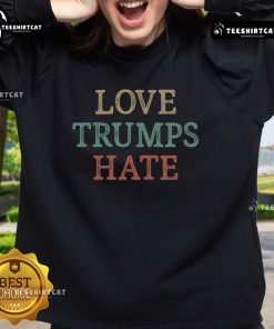 Vintage sweatshirt featuring 'Love Trumps Hate' design, perfect for expressing positivity and support.