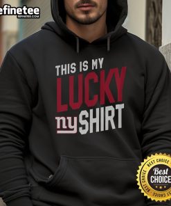Man wearing a New York Giants hoodie, showcasing team spirit and luck in a vibrant urban setting.