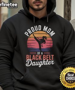 Alt Text: Proud mom wearing a hoodie celebrating her daughters black belt achievement in martial arts, showcasing family pride.
