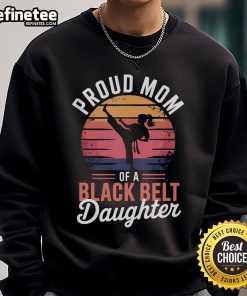 Alt Text: Proud mom wearing a sweatshirt that celebrates her daughters achievement as a black belt in martial arts.