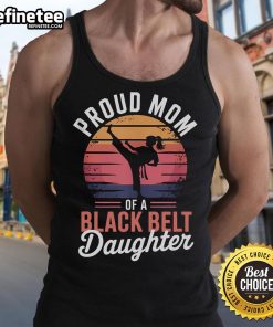 Alt Text: Proud mom wearing a tank top celebrating her daughter's black belt achievement in martial arts.