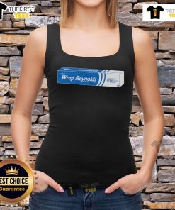 Model wearing a Nice That's A Wrap Reynolds tank top in a stylish outdoor setting, showcasing its trendy design.