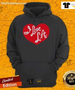 Cozy 'I Love LA' hoodie worn by a tourist, showcasing vibrant Los Angeles spirit and style in a sunny urban setting.