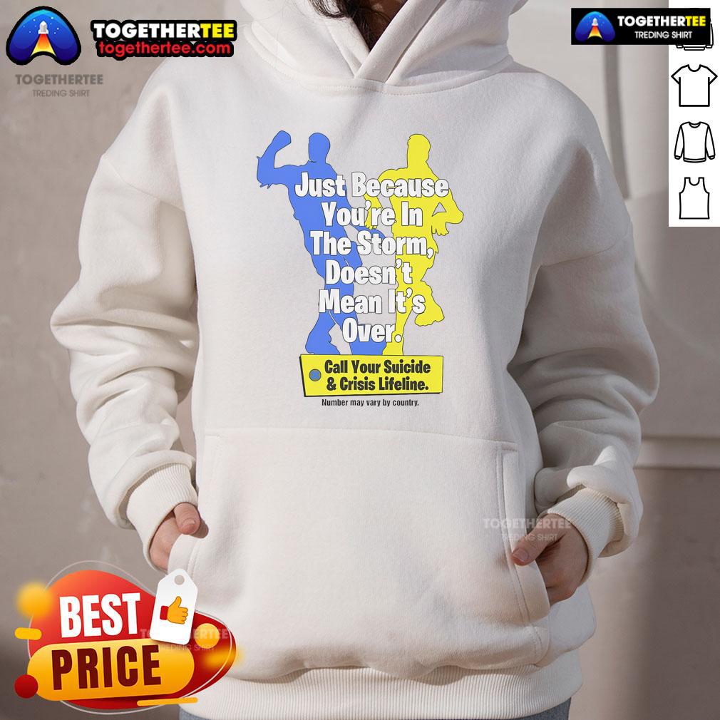 Official Just Because You're In The Storm Doesn't Mean It's Over Call Your Suicide & Crisis Lifeline Hoodie Official hoodie featuring the phrase 'Just Because You're In The Storm Doesn't Mean It's Over' promoting suicide crisis support.