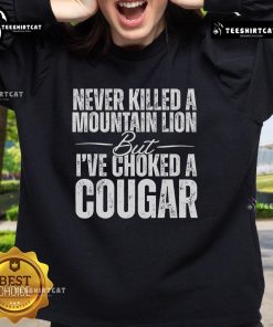 Alt Text: Official Never Killed A Mountain Lion But I've Choked A Cougar Sweatshirt in stylish design, perfect for animal lovers.