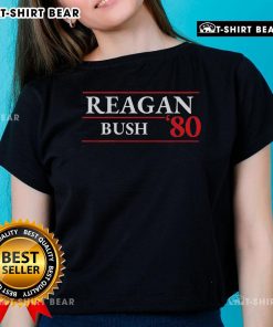 Official Reagan Bush 1980 Presidential Election ladies tee featuring vintage campaign graphics and patriotic colors.