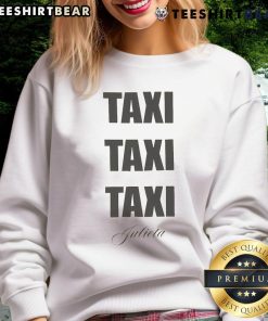 Sabrina Carpenter wearing a 'Taxi Taxi Taxi Julieta' sweatshirt, showcasing her stylish look and vibrant personality.