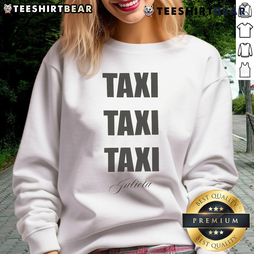 Official Sabrina Carpenter Taxi Taxi Taxi Julieta Sweatshirt Sabrina Carpenter wearing a 'Taxi Taxi Taxi Julieta' sweatshirt, showcasing her stylish look and vibrant personality.