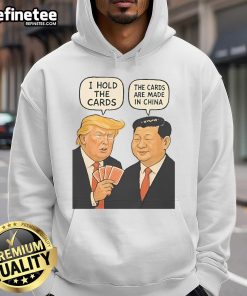 Alt Text: Official Trump 'I Hold The Cards, The Cards Are Made In China' Hoodie featuring bold text and patriotic colors.
