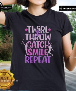 Smiling ladies in Official Twirler Majorettes Tee showcasing baton twirling skills with throws and catches.