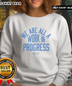 Alt Text: Official AFSP sweatshirt featuring 'We Are All A Work In Progress' design promoting mental health awareness.
