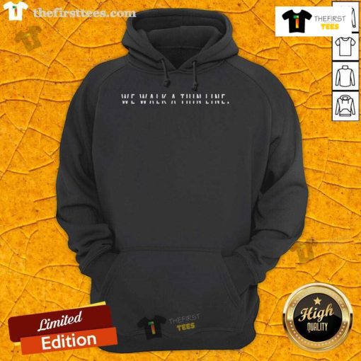 Minimalist hoodie featuring 'We Walk A Thin Line' stencil text quote for stylish and modern fashion.