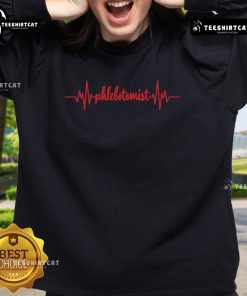 Original Phlebotomist Heartbeat design on a cozy sweatshirt featuring a syringe and blood, perfect for nurses.