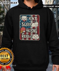 Cute cat in a patriotic hoodie, showcasing a 'Eat Sleep Ping Pong Repeat' design, perfect for table tennis lovers.
