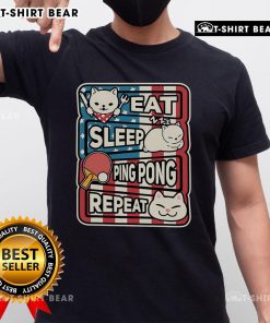 Pretty cat wearing a patriotic table tennis t-shirt with 'Eat Sleep Ping Pong Repeat' slogan, showcasing a fun sport spirit.