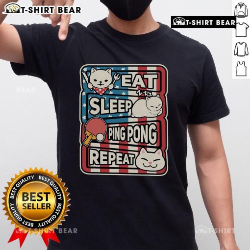 Pretty cat wearing a patriotic table tennis t-shirt with 'Eat Sleep Ping Pong Repeat' slogan, showcasing a fun sport spirit.