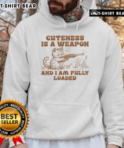 Stylish 'Pretty Cuteness Is A Weapon' cat hoodie featuring an adorable cat graphic, perfect for cozy fashion lovers.