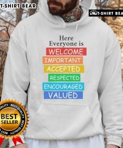 Cozy 'Pretty Here Everyone Is Welcome' hoodie displayed on a hanger, showcasing its vibrant design and inclusive message.