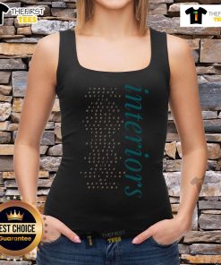 Stylish woman wearing 'Pretty Interiors Turn It Around' tank top, showcasing trendy fashion in a chic interior setting.