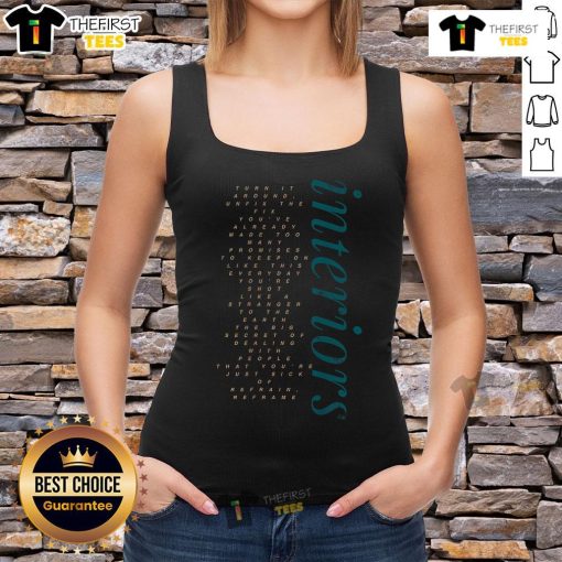 Stylish woman wearing 'Pretty Interiors Turn It Around' tank top, showcasing trendy fashion in a chic interior setting.
