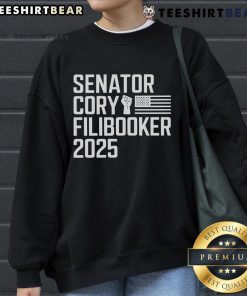 Senator Cory Booker wearing a 'Cory Filibooker' sweatshirt during a speech, showcasing his advocacy and style.