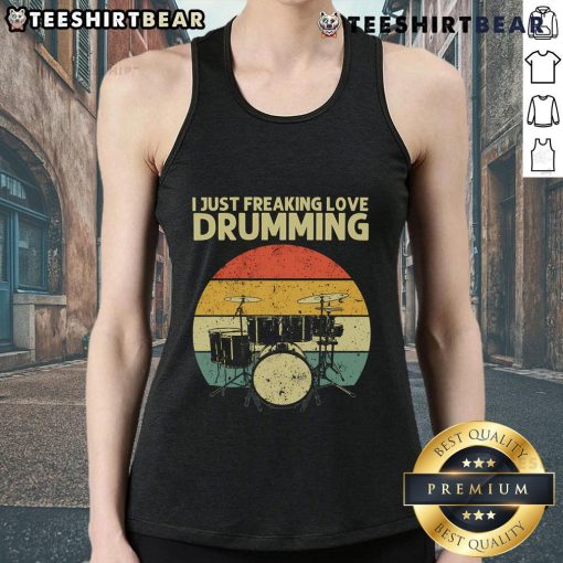 Retro sunset tank top featuring the phrase 'I Just Freaking Love Drumming' worn by a drummer against a colorful backdrop.