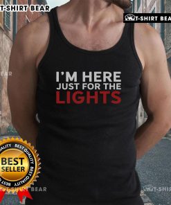 Stage crew lighting technician wearing 'Just Here For The Lights' tank top during a concert setup.