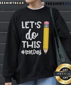 Teacher wearing a motivational sweatshirt for state testing day, inspiring students with 'Let's Do This' message.
