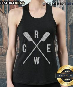 Top rowing crew with crossed oars, rowers in tank tops, coached by a dedicated team leader on the water.