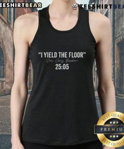 Alt Text: Top Senator Cory Booker in a 'I Yield The Floor' tank top during a 25-hour speech in 2025.