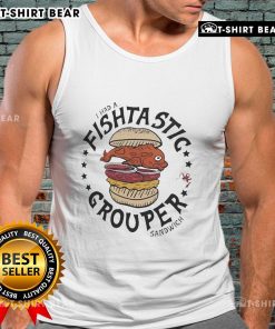 Fan wearing a 'Flavortown' tank top enjoying a grouper sandwich at a Tampa Bay Buccaneers game.