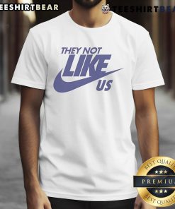 Top They Not Like Us Nike T-Shirt in black, featuring bold white text and a stylish design for casual wear.