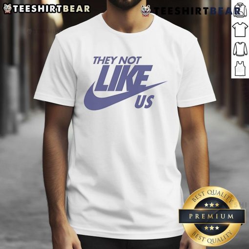 Top They Not Like Us Nike T-Shirt in black, featuring bold white text and a stylish design for casual wear.