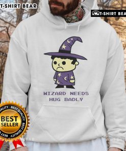 Cozy Top Wizard Needs Hugs Badly Hoodie featuring a whimsical design, perfect for fans of magic and comfort.